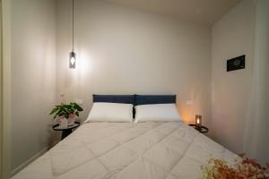 a bedroom with a large bed with two pillows at CASA Virginia - DEEP BLUE in Predore