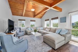 a living room with a couch and a tv at 3218 - Swab The Duck in Duck