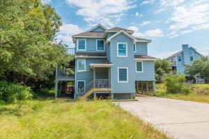 a blue house on the side of a road at 3944 - Carolina Escape in Duck