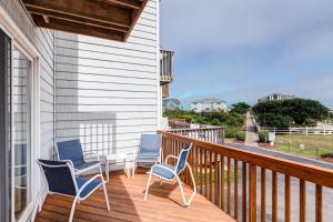 a porch with three chairs and a table on it at 4205 - Schwartz in Duck +26 photos