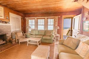 a living room with a couch and a fireplace at 5441 - Rascoe in Nags Head