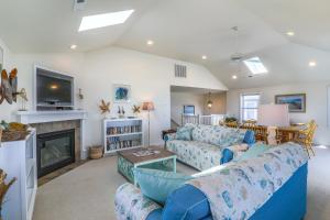 a living room with a couch and a fireplace at 4759 - Sun Daze in Kitty Hawk Beach