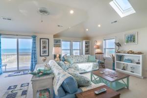 a living room with a couch and a table at 4759 - Sun Daze in Kitty Hawk Beach