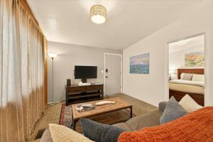 a living room with a couch and a tv and a bed at Red Ivy #5 in Boise