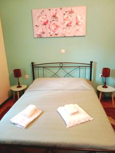 a bedroom with a bed with two towels on it at Konstan'shouse in Mytilene