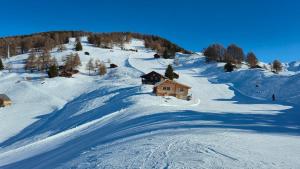 a snow covered hill with a house on it at IMMEUBLE Panorama in Les Collons