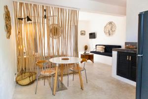 a living room with a table and chairs and a couch at NEW MORINGA in Las Terrenas