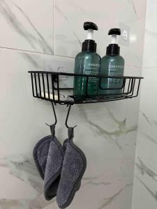 a shelf with two bottles of detergent and two shoes at Studio apartment- private entry! in Homestead