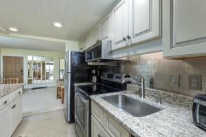 a kitchen with a sink and a refrigerator at 5695 - Pelican's Perch in Nags Head +8 photos