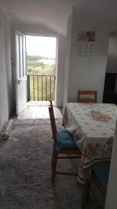 a bedroom with a bed and a door to a balcony at Quarto no Sótão in Coruche