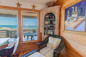 a living room with a chair and a table at 5451 - Richardson in Nags Head