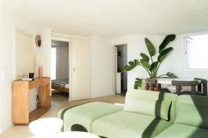a living room with a couch and a table at Praia das Maçãs Sea view Retreat in Colares