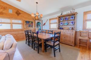 a dining room with a table and chairs at 5451 - Richardson in Nags Head +51 photos