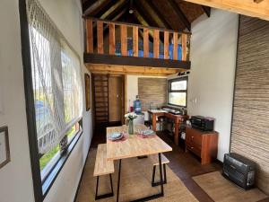 a small room with a table and a balcony at Tiny House, Tiny Black Frutillar in Frutillar