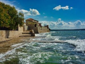 a body of water with buildings on the shore at Villa Jessica Apartments in Novigrad Istria