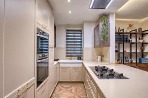 a kitchen with white cabinets and a stove top oven at NEW - Unique 3BR Apartment in Sought-After Area of Malta by SF Homes in Hal Ghaxiak