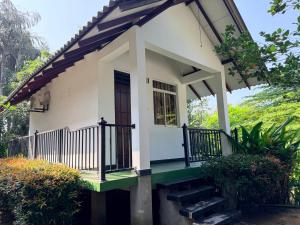a small house with a porch and stairs at Greenfield Haven in Polonnaruwa