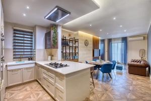 a kitchen with a table and a dining room at NEW - Unique 3BR Apartment in Sought-After Area of Malta by SF Homes in Hal Ghaxiak