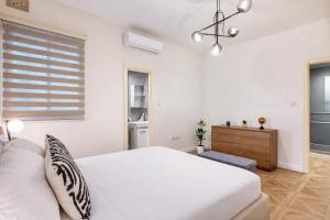 a white bedroom with a bed and a window at NEW - Unique 3BR Apartment in Sought-After Area of Malta by SF Homes in Hal Ghaxiak +37 photos