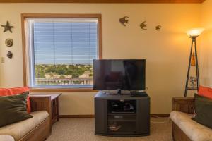 a living room with a flat screen tv in front of a window at 7504 - Sunrise-Sunset in Avon