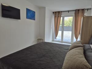 a bedroom with a large bed and a sliding glass door at Apartment Natalija A2 ground floor in Krk