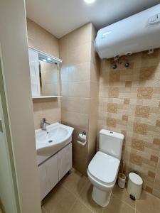 a small bathroom with a toilet and a sink at Boutique Rooms Desi 2 in Pleven