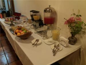 a table with a white table cloth with forks and knives at Hotel Doria in Rancagua