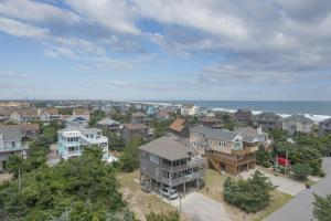 an aerial view of a city with houses and the ocean at 7651 - Sandrose in Avon