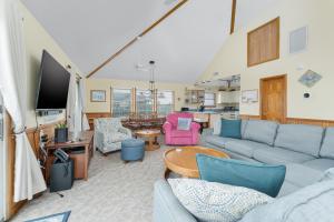 a living room with a couch and chairs and a tv at 7651 - Sandrose in Avon
