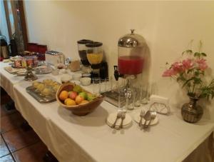 a table topped with a buffet of food and drinks at Hotel Doria in Rancagua +28 photos