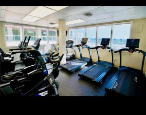 a gym with a row of tread machines in a room at Condo-Hotel on Collins ave in Sunny Isles Beach