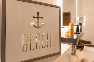 a sign for a bathroom with an anchor on a sink at Ferienwohnung Strand-Domizil Zingst in Niederdorla +22 photos