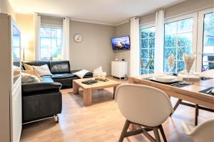 a living room with a couch and a table at Ferienwohnung Strand-Domizil Zingst in Niederdorla