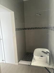 a bathroom with a toilet in a shower at House Stillmar in Walvis Bay +9 photos