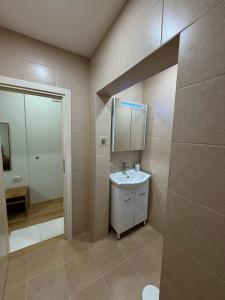a bathroom with a sink and a mirror at Boutique Rooms Desi 3 in Pleven