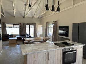 a kitchen with a table and a living room at House Stillmar in Walvis Bay