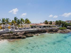 an aerial view of a resort with blue water at Boutique Hotel Bougainvillea in Kralendijk