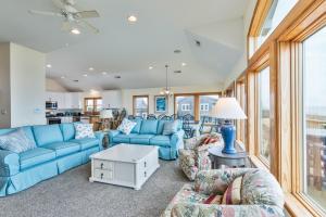 a living room with blue couches and a table at 2440 - Solitude South in Duck