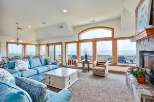 a living room with a blue couch and a fireplace at 2440 - Solitude South in Duck
