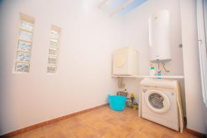 a laundry room with a washing machine in it at Casa Conil Private 25m Heated Pool with Hydraulic Mobility Lift in Conil