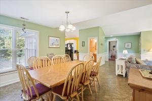 a dining room and living room with a table and chairs at 4620 - Flip Flop Inn in Southern Shores