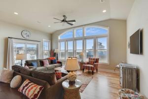 a living room with a couch and a large window at 4108 - New Beginnings in Duck