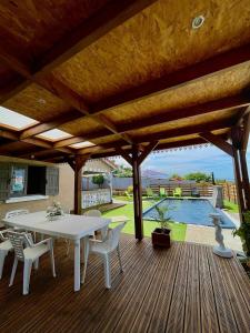 a patio with a table and chairs on a wooden deck at La Kaz Baz ' île in Étang-Salé
