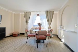a dining room with a table and chairs and a window at KasselRooms Comfort Studio in Kassel