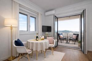 a living room with a table and chairs and a room with a view at Pula Paradise in Pula