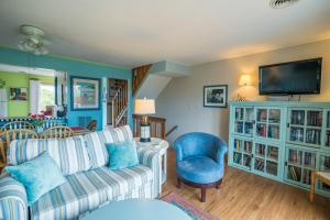 a living room with a couch and a tv at 4204 - Outer Thanks in Duck