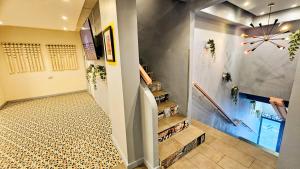 a hallway with stairs in a house at Somos Hotel San Juan in San Juan