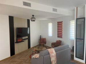 a living room with a couch and a tv at La costière in Nice