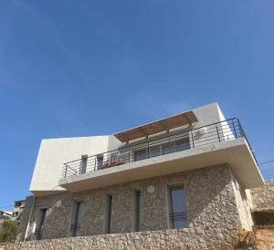 a building with a balcony on top of it at La costière in Nice