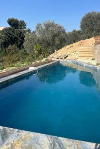 a large pool of blue water next to some stairs at La costière in Nice